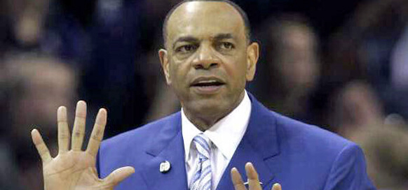 Man in blue suit gesturing with hands